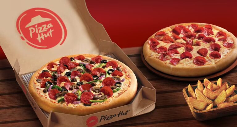 Two Pizza Hut pizzas, one loaded with toppings and the other with pepperoni, served alongside potato wedges