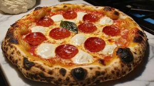 Baked pepperoni pizza with bubbly cheese and crispy crust on a white surface