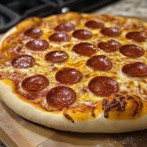 Close-up of a freshly baked pepperoni pizza with golden crust and melted cheese