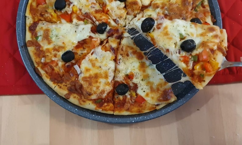 A slice of pizza, bursting with melted cheese and savory toppings