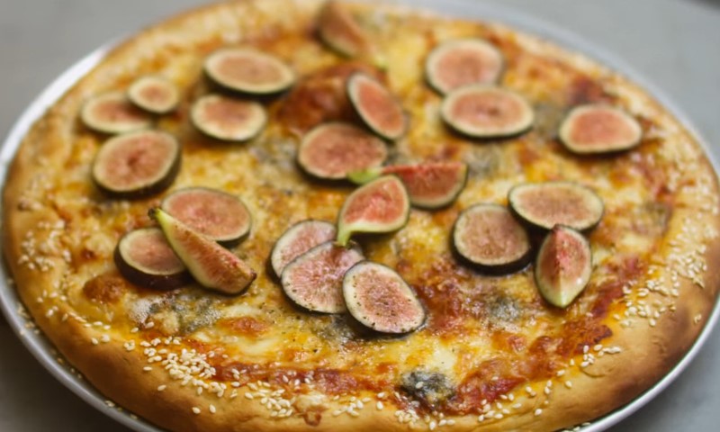 A pizza topped with fresh figs