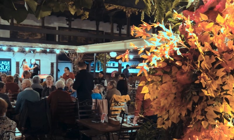 A cozy restaurant scene with diners sitting at tables
