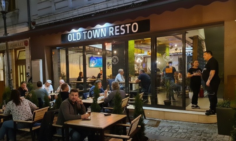 Outdoor seating at a cozy restaurant named "Old Town Resto."